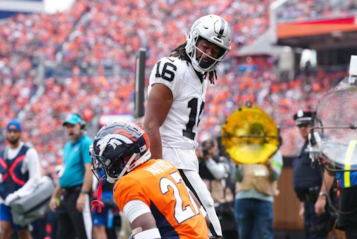 Las Vegas Raiders wide receiver Jakobi Meyers (16) reacts towards Denver Broncos cornerback Damarri Mathis (27) following his touchdown reception in the first quarter at Empower Field at Mile High.